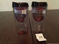 Both clear insulated tumblers front view showing labels and height