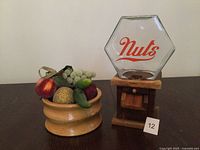 nut dispenser and wooden bowl side by side