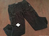 Full view of jogger pants laid flat showing overall condition, pockets, and cuffs