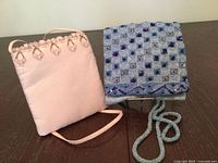 Front view of both handbags showing designs and straps