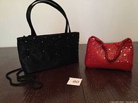 Both handbags side by side on table