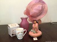Overall view of all four items: lamp, hat, mug with box, vase