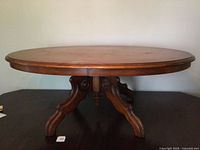 Full view of oval coffee table, pedestal base