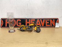 Overview of sign, pint glass, motorcycle model