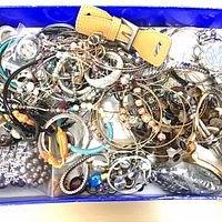 Overview of box filled with assorted jewelry pieces
