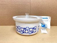 full view of ceramic microwave slow cooker with lid and manual