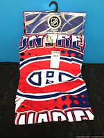 Towel folded with Montreal Canadiens graphics and packaging visible