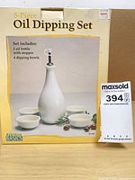 Front of retail box showing oil bottle and four bowls