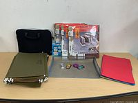 Group shot of all items on table showing bankers box packs, hanging folders, file folders, laptop sleeve, mesh tray with accessories