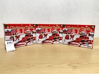Front view showing three boxed Christmas Track sets