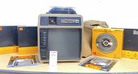 Front view of Kodak Ektagraphic 260 viewer with carousel on top and accessories around