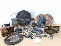 Full lot overview showing metalware, glass, wood, flatware, knives and collectibles