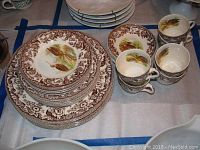 Array of plates, cups and saucers showing overall lot