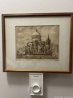 Full view of framed etching showing artwork, mat, and frame