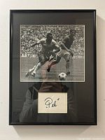 Framed photo showing entire item with autograph mat