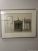 Full view of framed engraving on wall showing mat and metal frame