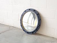 Front view of round convex mirror against wall