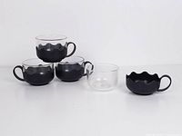 Five cups shown, four assembled, one glass separated from holder to illustrate removable design