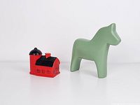 Green Dala horse and red barn shakers side by side