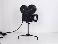 Front view of camera-shaped desk lamp on tripod stand
