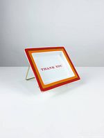 Front view of porcelain tray on stand showing text and borders