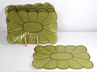 Stack of eight green vinyl placemats, one displayed upright on stand