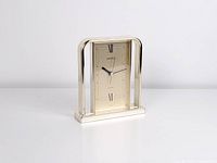 Front view showing full clock, gold-tone frame, dial and hands