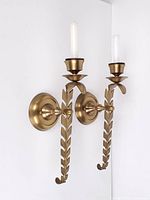 Full view of both brass wall sconces mounted, showing overall design and finish