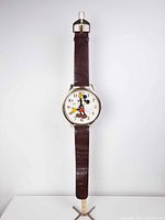 Full view of wristwatch-style wall clock showing overall size and strap