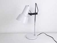 Full view of lamp showing shade angle, chrome stem, base and cord