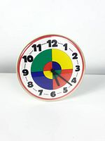 Front view of multicolored wall clock showing face and hands