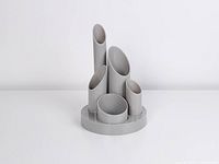 Front view showing five grey tubes on round base