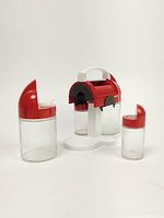 Full set disassembled showing caddy, one cruet and one toothpick holder