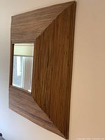 Front view of bamboo framed mirror on wall