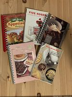 All five cookbooks spread on table