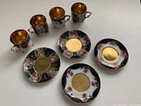 Full set laid out showing four cups and four saucers