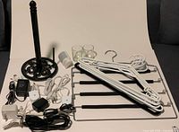 All items laid out: towel holder, candle holders, hangers, night lights, cords