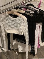 Rack of lace and mesh tops and cover-ups