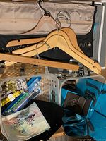 assorted organizers, wooden hangers, Birks packaging and basket contents overview