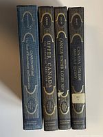 Spine view of all four hardcover volumes showing titles and uniform design