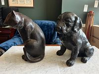 Front view of cat and dog sculptures