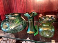 Three Czech iridescent glass vases on shelf
