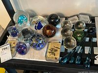 Overall view of all art glass paperweights on shelf