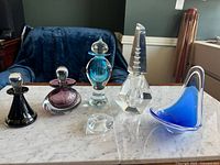 All six art glass pieces displayed on marble surface