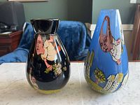 Front view of both vases showing painted figures and gloss finish