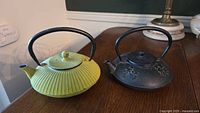 Overview of both teapots on table