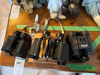 Three binoculars laid out side by side
