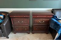 Front view of both matching side tables showing drawer fronts, hardware, bun feet