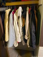 Closet rod showing multiple jackets, coats and vests