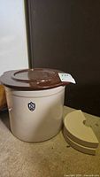 Crock with lid and one weight visible